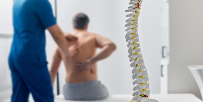 Orthopaedic surgeon treating patient with lower back pain